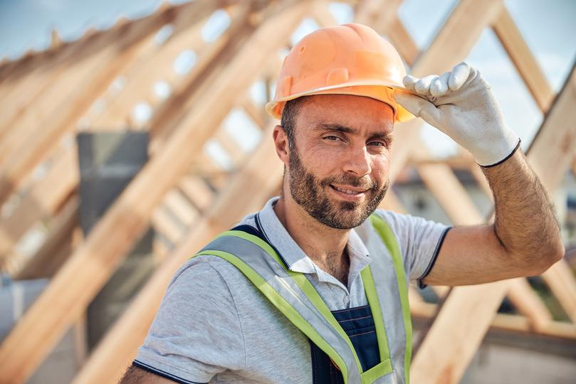 A roofer installing a new roof on a house